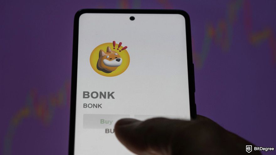 Best Solana meme coins: a smartphone with the Bonk logo on it.