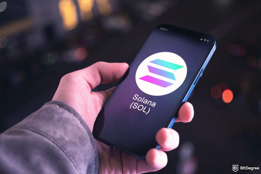 Best Solana wallet: a person holding a phone with the Solana logo on it.