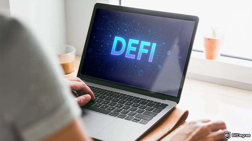 Best stablecoin: a person using a laptop with DeFi logo displayed on its screen.
