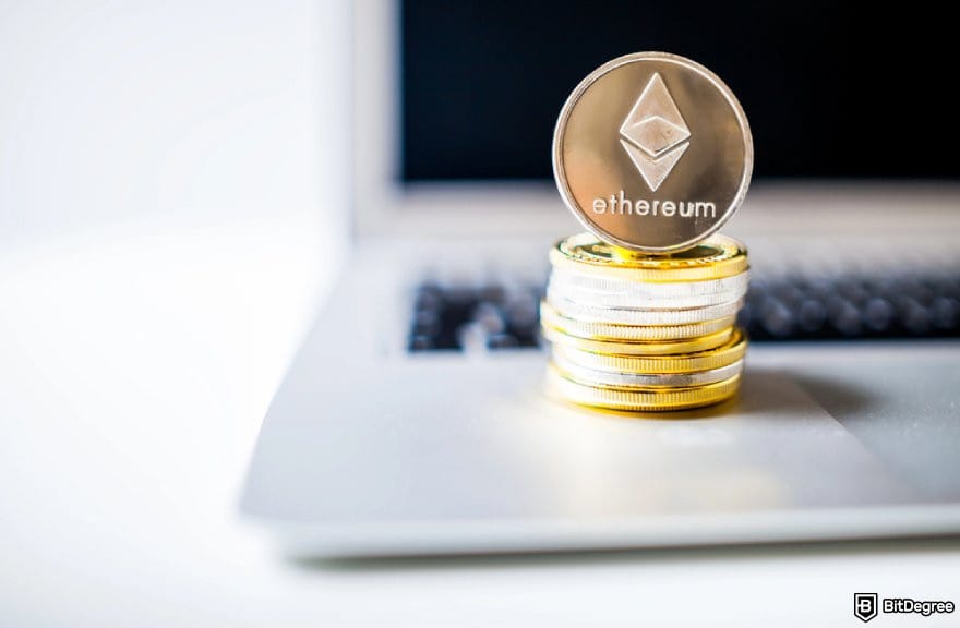 Best staking crypto: a stack of ETH coins on a laptop.