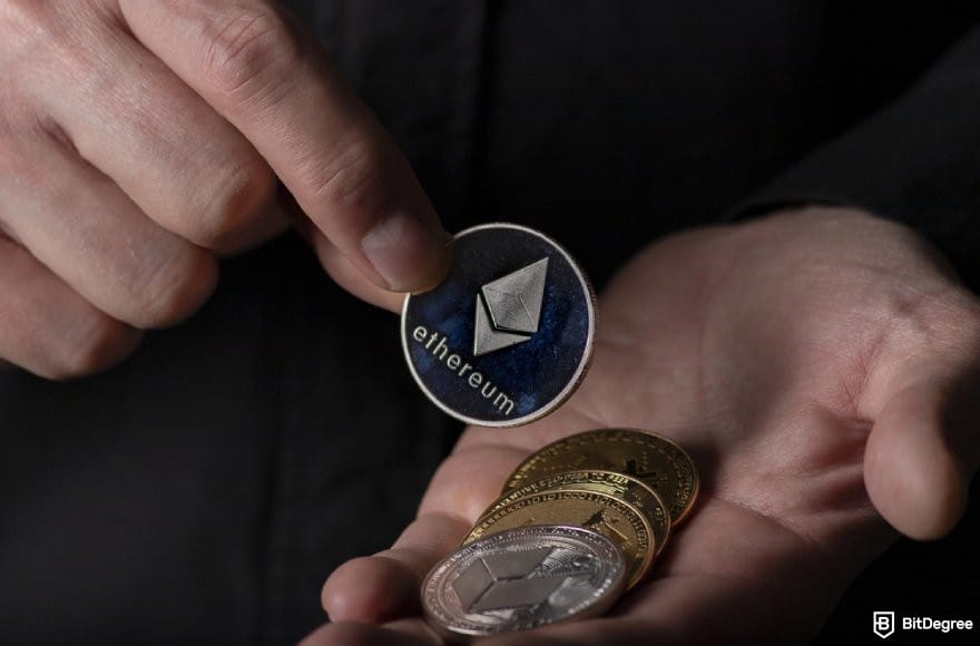 Best staking crypto: a person holding an ETH coin and other crypto coins.