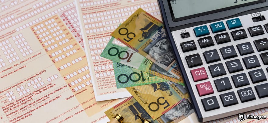 Best way to send money to Australia: Australian tax forms with AUD bills and a calculator placed on top.