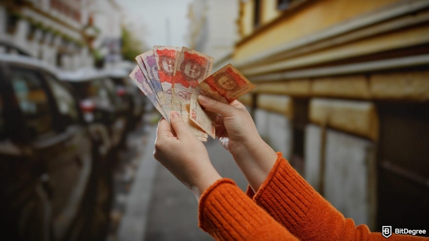 Best way to send money to Colombia: a person holding Colombian pesos on an street.