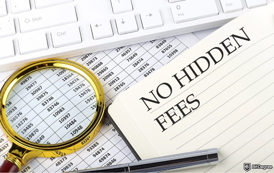 Best way to send money to El Salvador: a magnifying glass and a notebook with the words HIDDEN FEES on it.