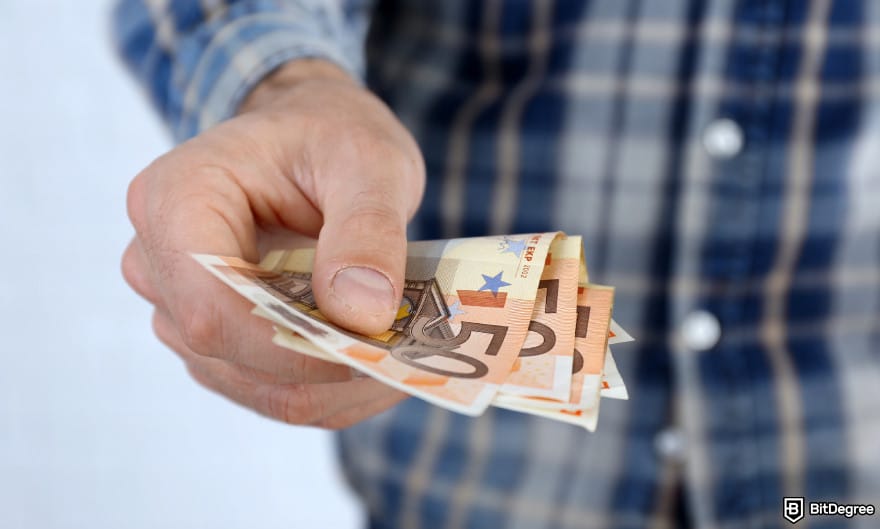 Best way to to send money to Europe: man holding euro bills to illustrate sending money online.