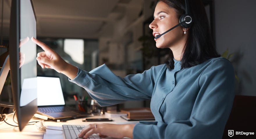 Best way to send money to Pakistan: a support agent at a desk during nighttime shift.
