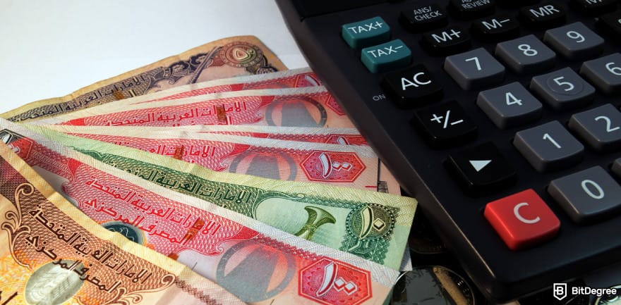 Best way to send money to Pakistan: dirham bills and a calculator on a table.