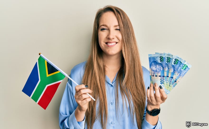 Best way to send money to South Africa: woman holding South African flag and ZAR.