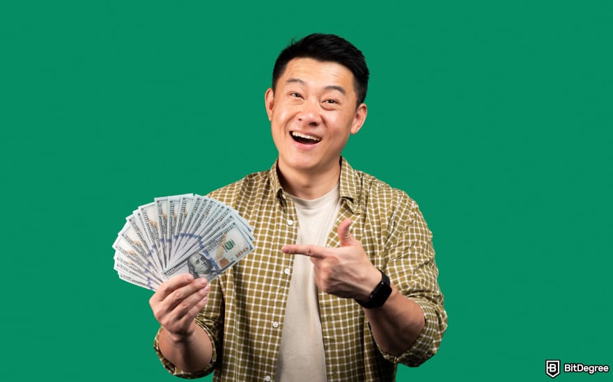 Best way to send money to South Korea: man holding USD bills.
