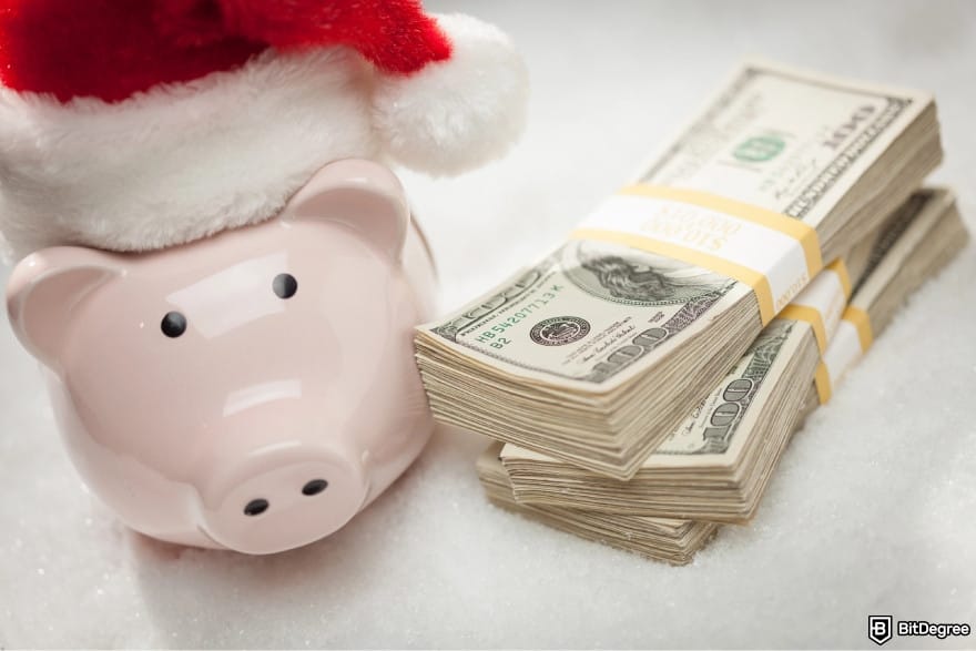 Best way to send money to Thailand: a stack of cash next to a piggy bank wearing a Christmas hat.