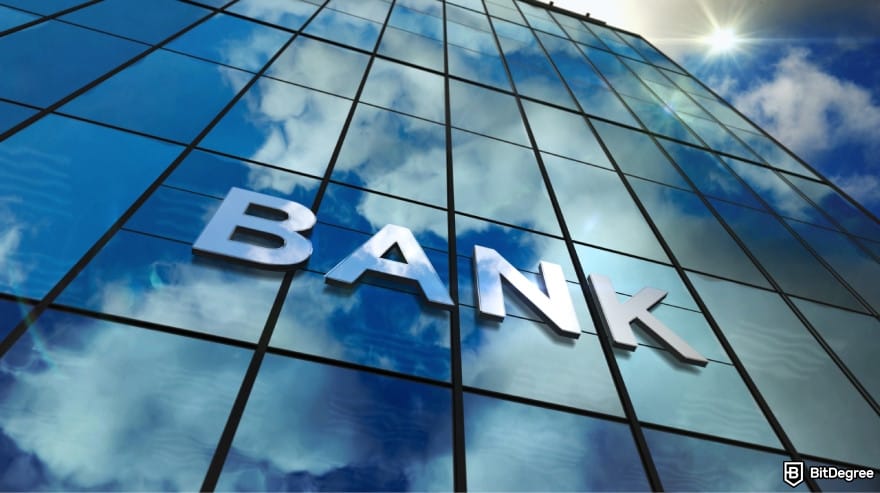 Best way to transfer money between banks: a glass building with the word BANK on it.