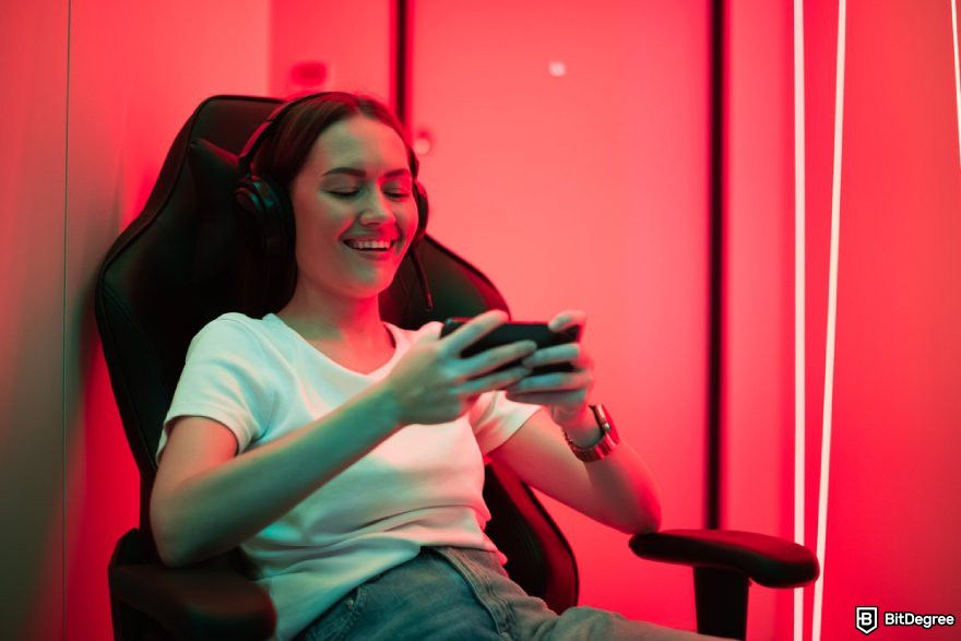 Best XRP meme coins: a person sitting on a chair holding a mobile phone.