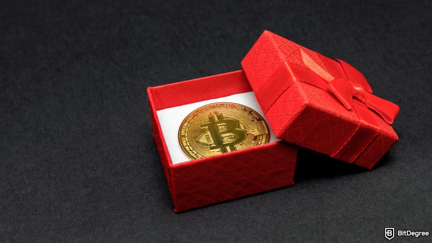 Binance taxes: Bitcoin coin in a red gift box.