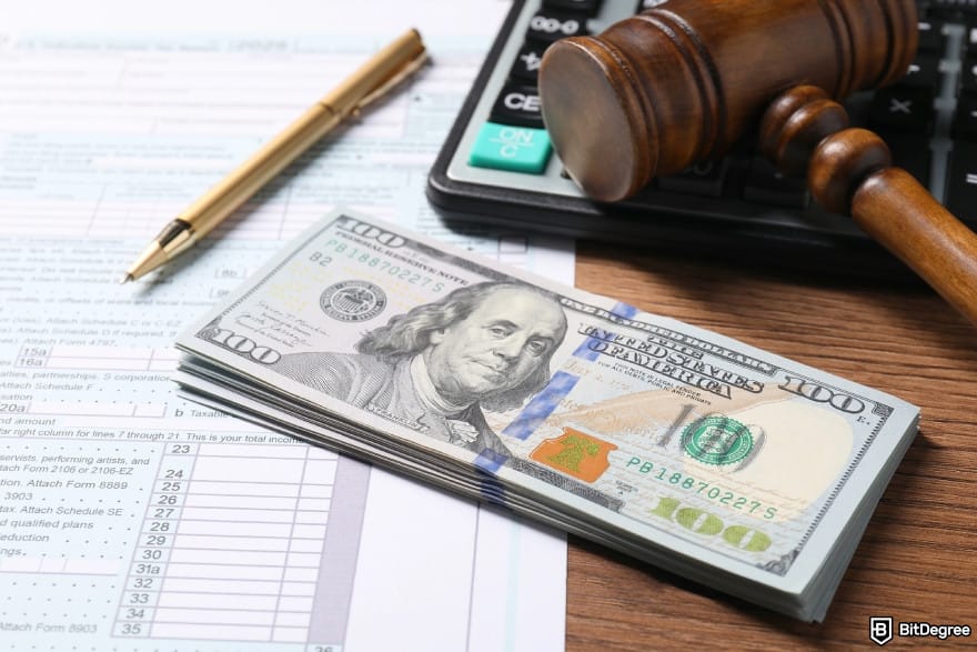 Binance taxes: tax return form, dollar banknotes, gavel, pen and calculator.