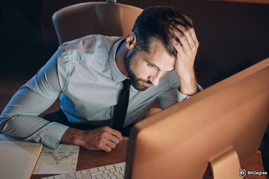 Bitcoin cycles: frustrated young man holding head.