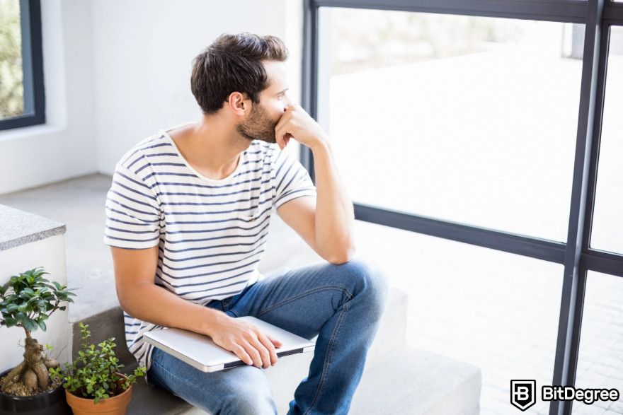 Bitcoin price prediction: a man sitting and thinking.