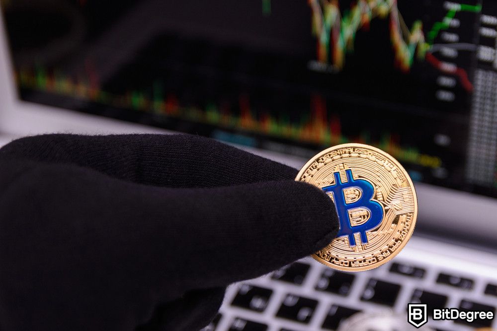 Lừa đảo Bitcoin: một người đeo găng tay đen cầm Bitcoin.