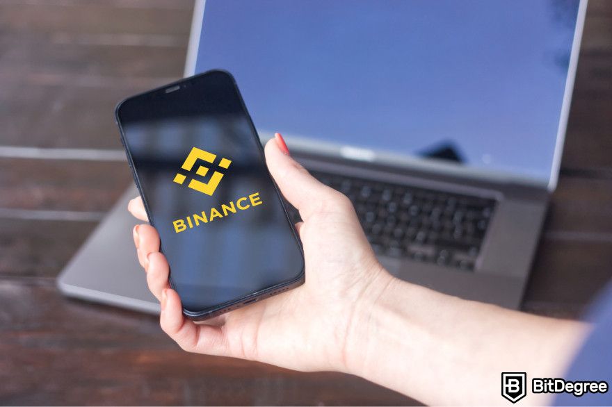 Bitcoin staking: Binance logo on a mobile phone.