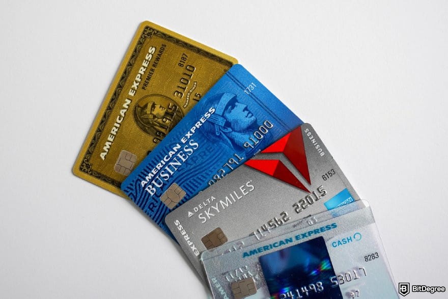 Bitget review: four different AMEX cards on a white surface.