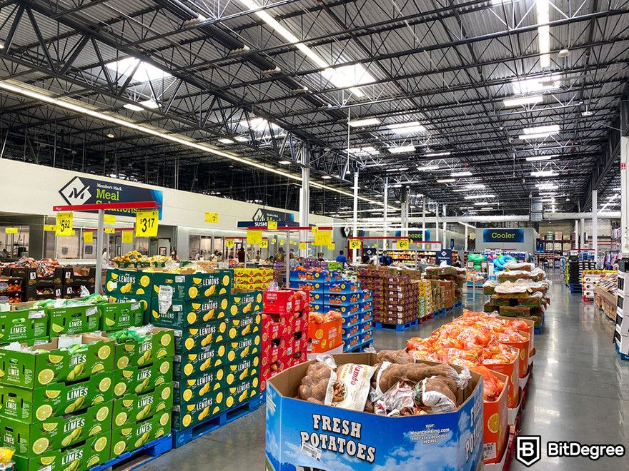 Blockchain accounting: a grocery store produce aisle with colorful fruits and vegetables on display.