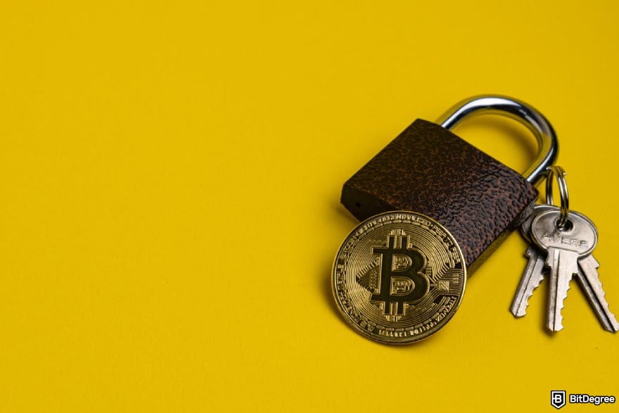 Blockchain.com review: a BTC coin, a padlock, and some keys on a yellow surface.