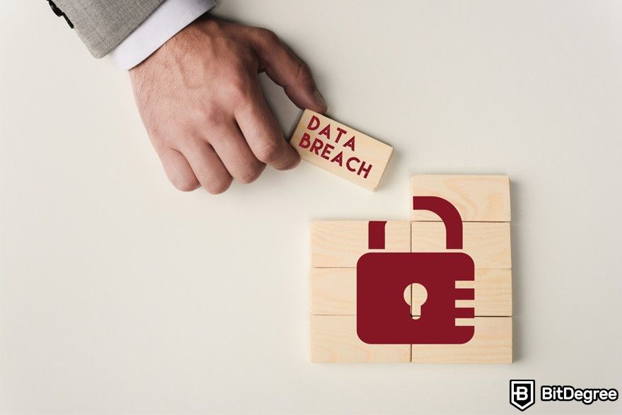 Blockchain education: A man holding a block with 'data breaching' lettering.
