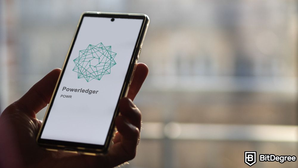 Blockchain for energy: a close up on logo Powerledger (POWR) on a smartphone.