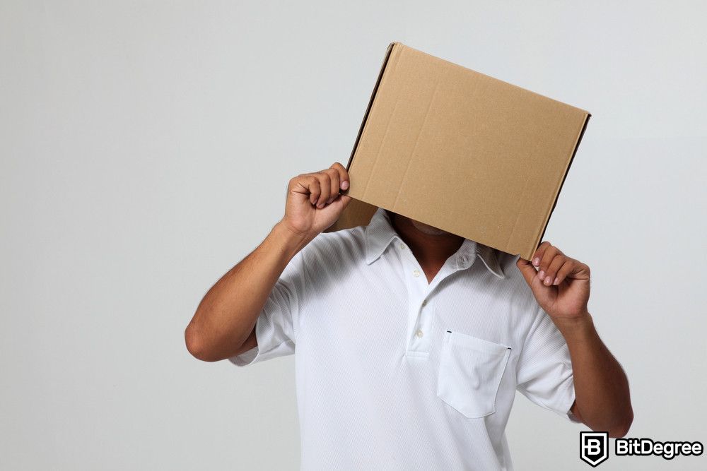 Blockchain for enterprises: a man covering his face with a box.