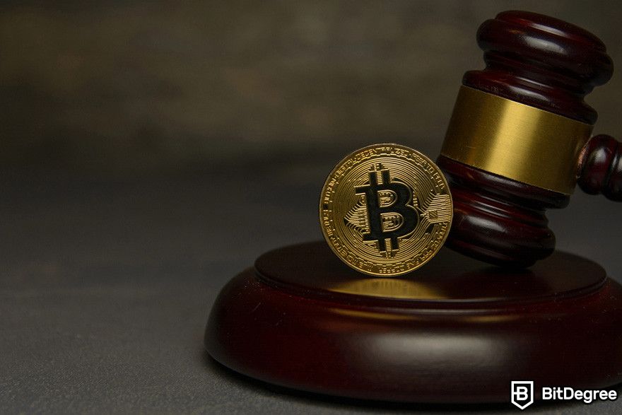 Blockchain in banking: a Bitcoin coin on top of a gavel.