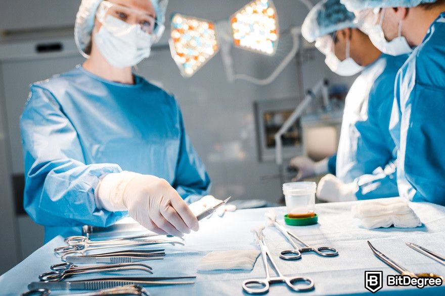 Blockchain in healthcare: Doctors and nurses in uniform doing surgery.