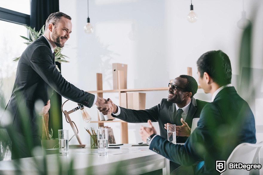 Blockchain in insurance: businessmen shaking hands.