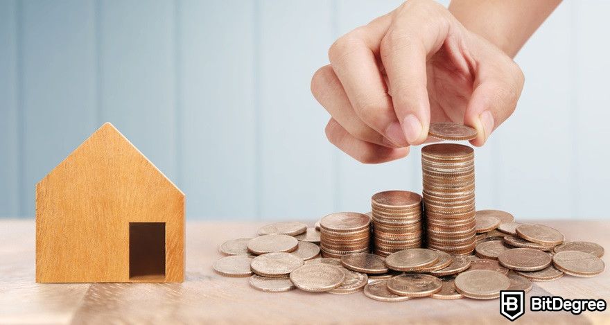 Blockchain in real estate: Money stacks beside a house miniature.