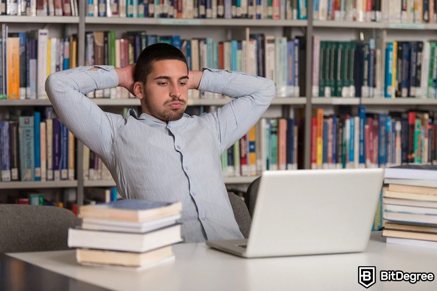 Blockchain in real estate: A confused man looking at a laptop.