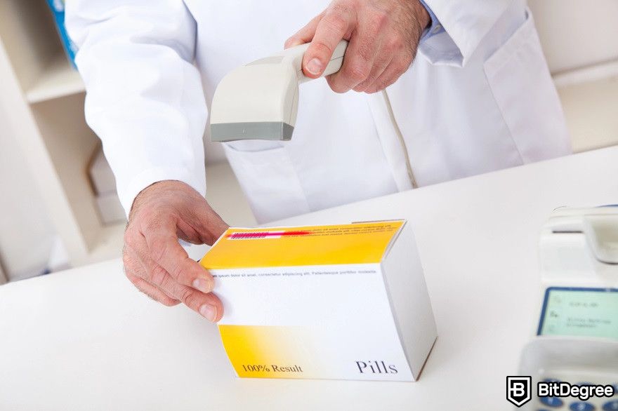 Blockchain in supply chain: A pharmacist scanning a medicine box's barcode.