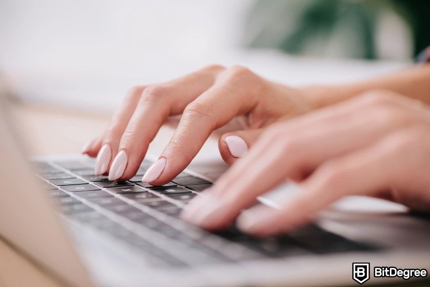 Blockchain platform: Female fingers typing on a keyboard.