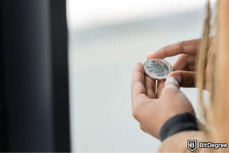 Bonk token airdrop: a person holding Bitcoin in their hands.