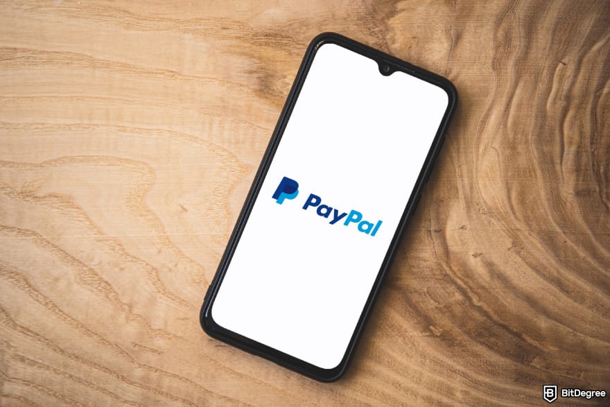 Buy XRP with PayPal: a phone displaying PayPal logo.