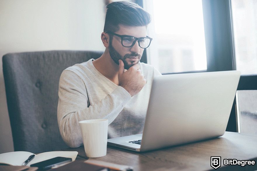 Bybit affiliate: a person sitting while looking at a laptop.