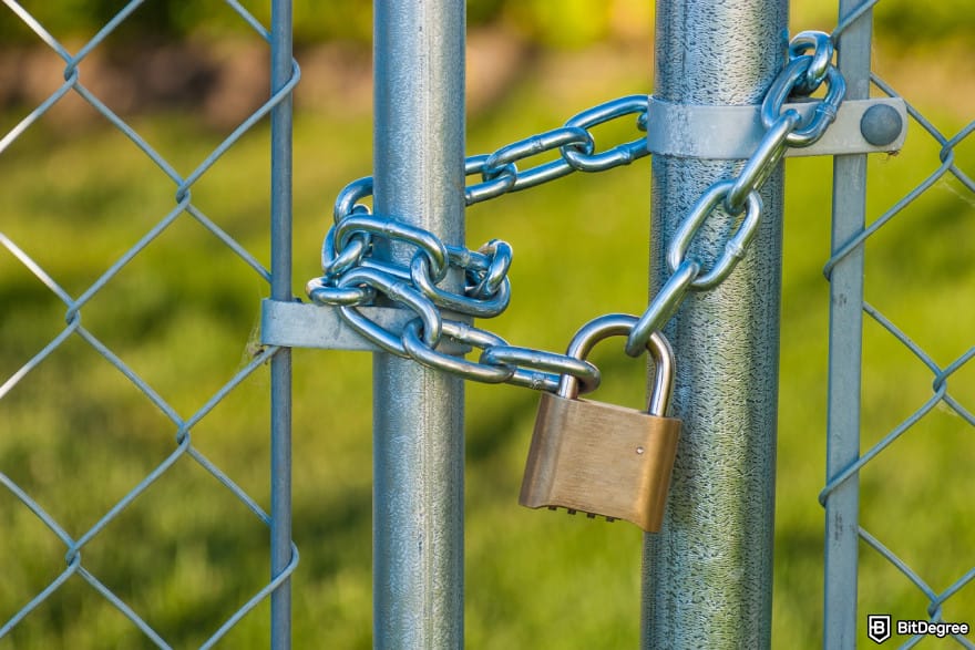 Bybit Earn: a chain and lock on a chainlink fence to illustrate lock-up period.