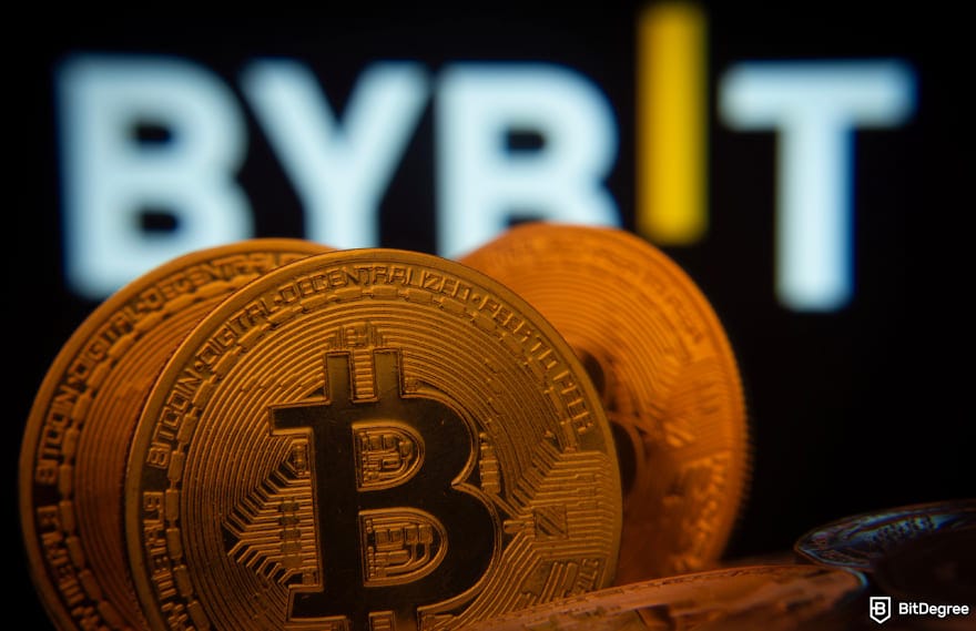Bybit margin trading: Bitcoin in front of a screen showing Bybit logo to illustrate BTC trading.