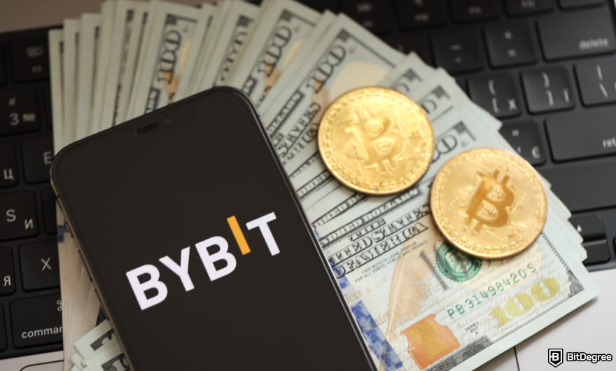 Bybit margin trading: phone showing Bybit logo on top of fiat and crypto currencies to illustrate crypto trading.