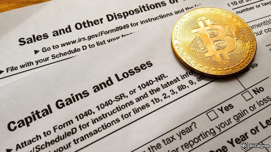 Bybit taxes: Schedule D tax form with a physical Bitcoin coin placed on top.