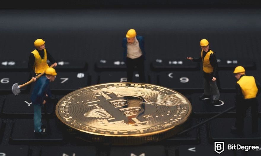 CGMiner review: miners miniature figures dig Bitcoin on a computer keyboard.