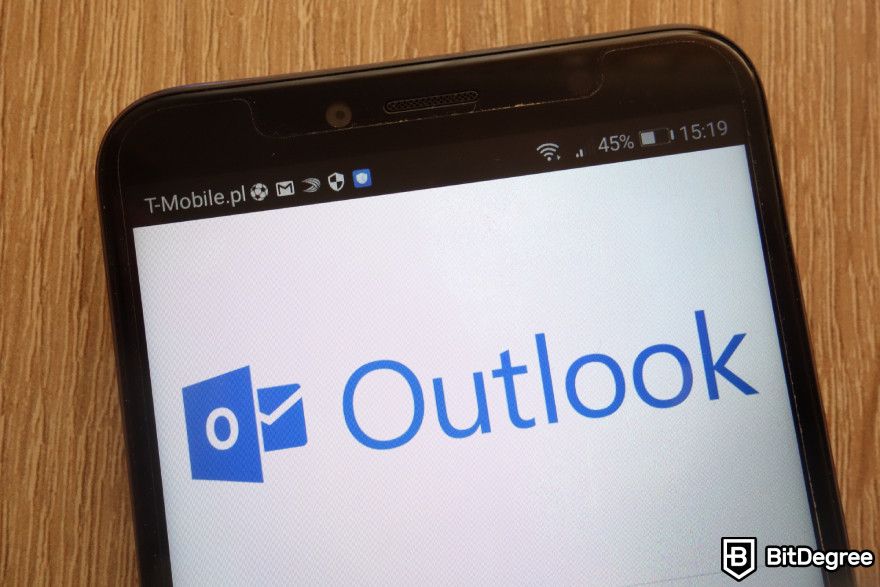 ChatGPT integration: Outlook logo displayed on a phone.