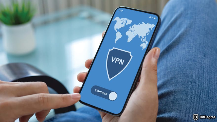 Chinese crypto coins: a person hands hold phone with app VPN on screen.