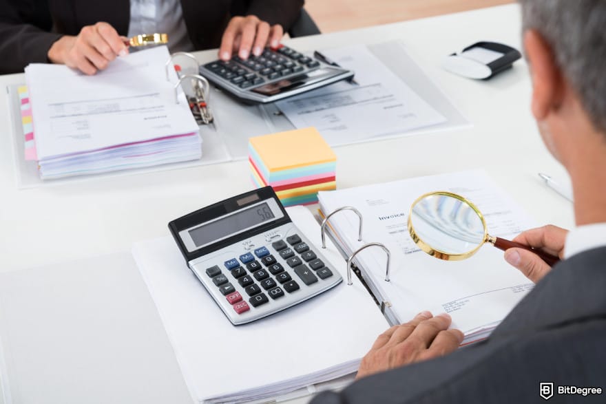 Coinbase taxes: businesspeople scrutinizing tax reports.
