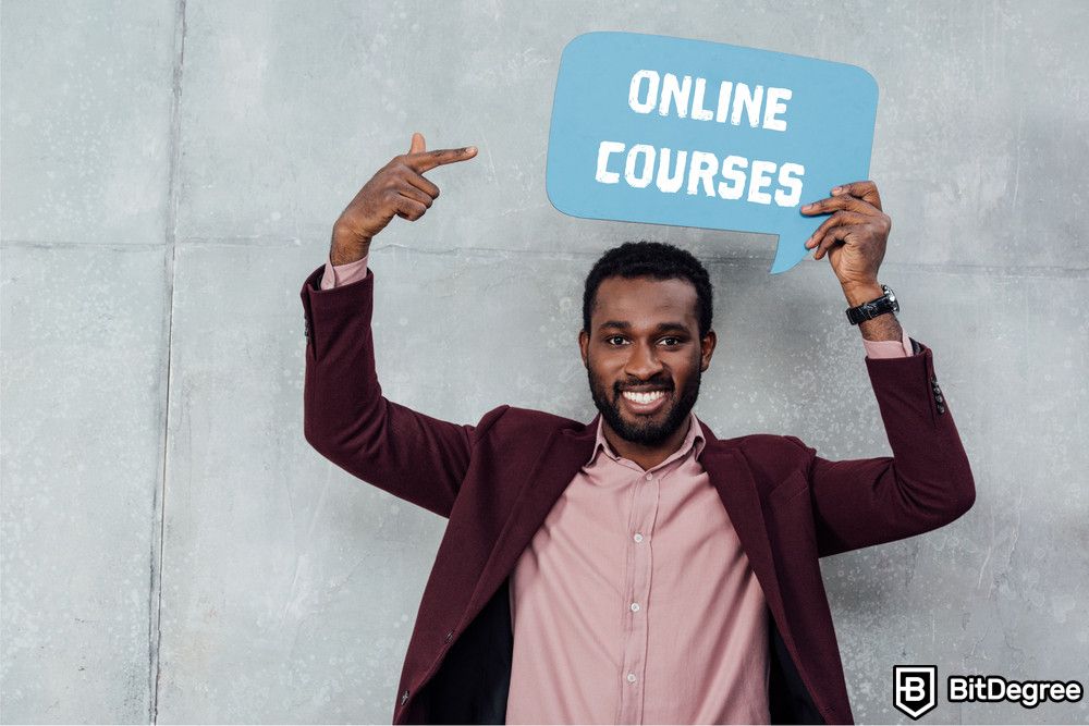 Crypto Discords: a businessman looking at camera and pointing with finger at speech bubble with online courses lettering.