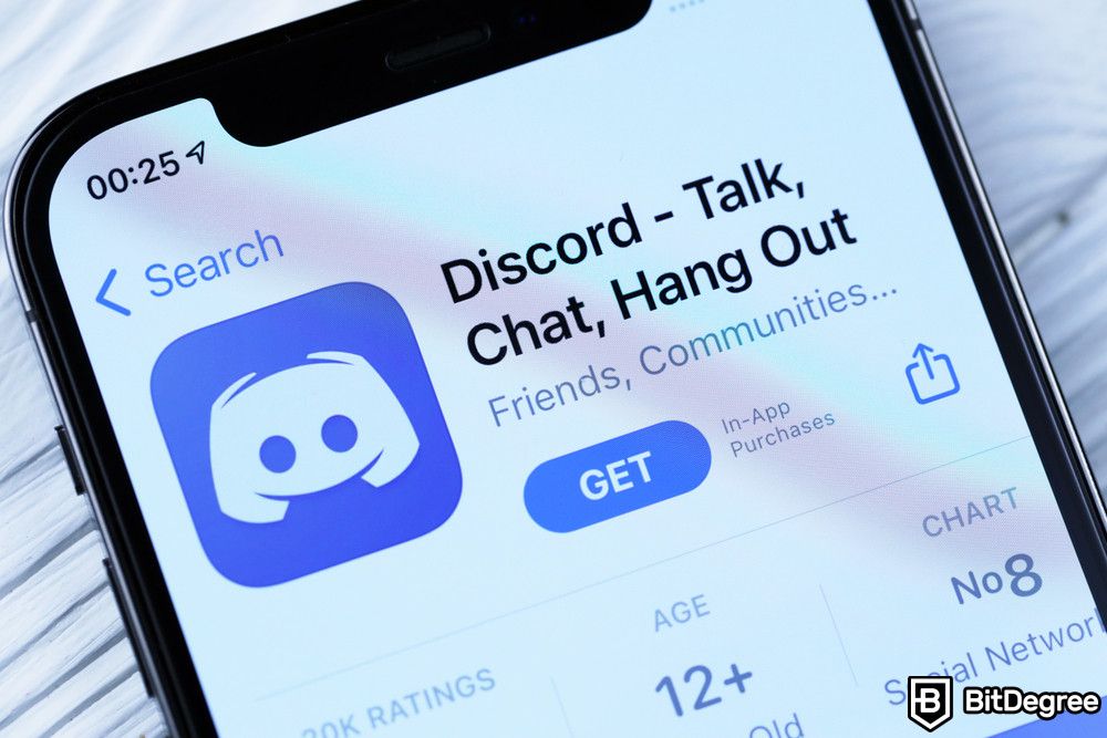 Crypto Discord: Biểu tượng Discord và ứng dụng từ App store trên màn hình hiển thị iPhone 12 pro.