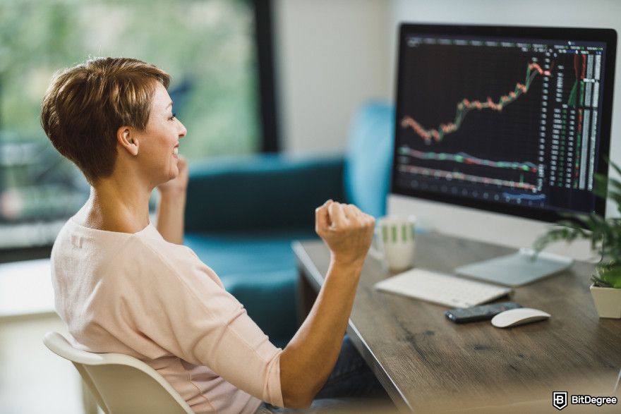 Crypto funding rates explained: a happy woman doing trades.