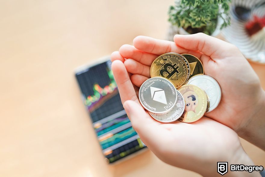 Crypto index fund: a person holding various crypto coins.